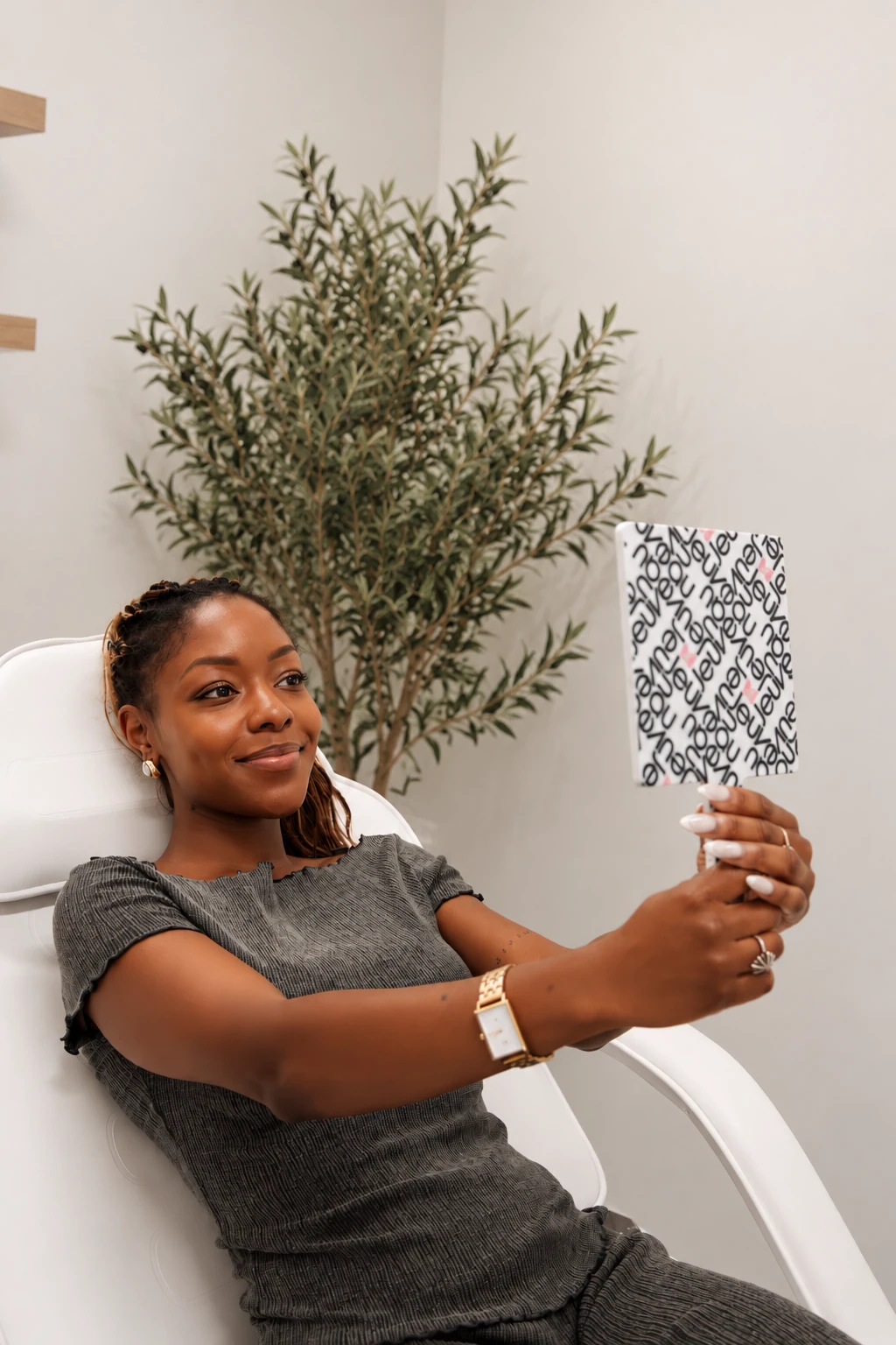Patient checking her results in a mirror after a neuromodulator (tox) treatment at Push Med in Greenville, SC