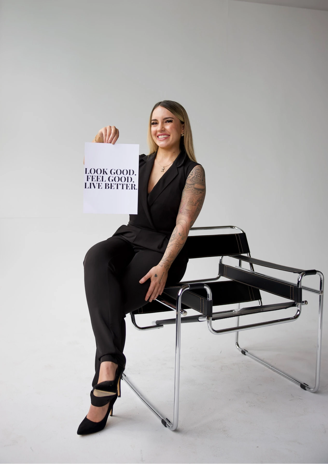 Push Med team member holding a Look Good. Feel Good. Live Better. sign