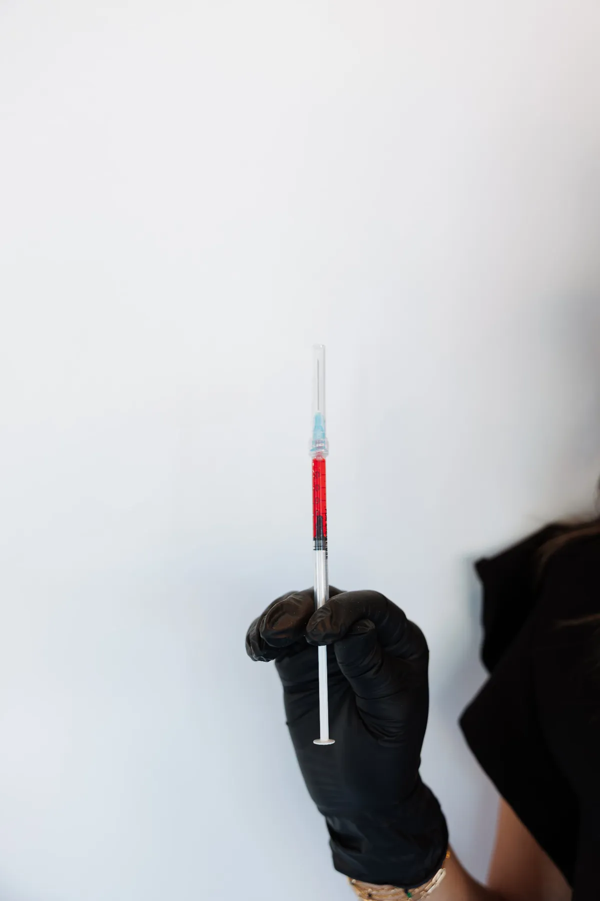 Gloved hand holding a prepared vitamin injection at Push Med in Greenville SC