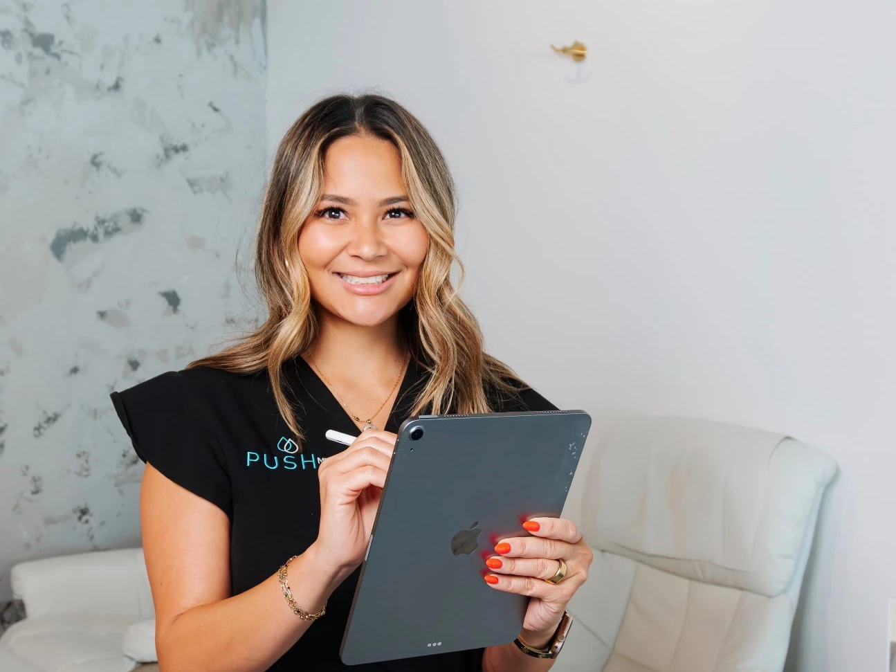 Push Med provider holding an iPad to review a patient's health history